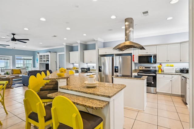 931 S Ocean Blvd, North Myrtle Beach, SC 29582 - kitchen featuring appliances with stainless steel finishes, a kitchen island, light tile patterned floors, a ceiling fan, and crown molding
