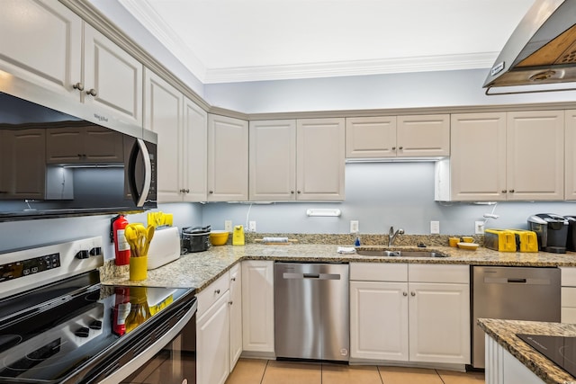931 S Ocean Blvd, North Myrtle Beach, SC 29582 - kitchen with stainless steel appliances, exhaust hood, crown molding, light tile patterned flooring, and light stone countertops