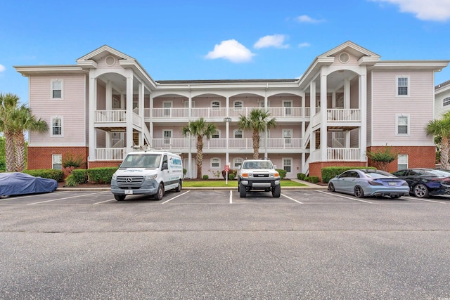 4142 Hibiscus Dr Unit 20-202, Little River, SC 29566 - view of building exterior featuring uncovered parking and stairway