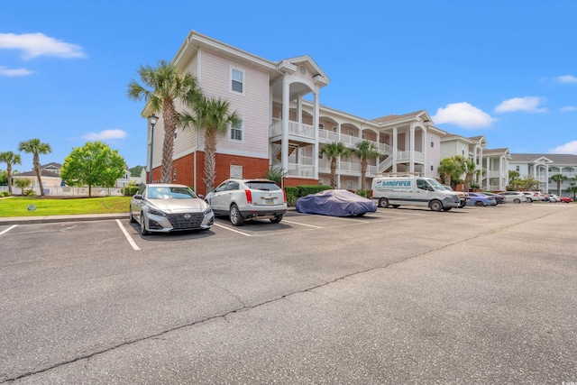 4142 Hibiscus Dr Unit 20-202, Little River, SC 29566 - view of building exterior with uncovered parking and a residential view