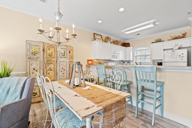 4142 Hibiscus Dr Unit 20-202, Little River, SC 29566 - dining area with a chandelier, ornamental molding, light wood-type flooring, and recessed lighting