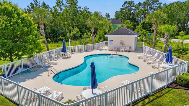 4142 Hibiscus Dr Unit 20-202, Little River, SC 29566 - community pool featuring a patio area and view of wooded area