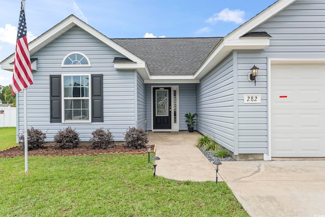 282 Foxpath Loop, Myrtle Beach, SC 29588 - view of front facade with an attached garage, a front lawn, and a shingled roof