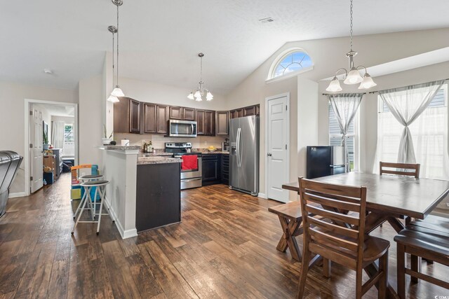 282 Foxpath Loop, Myrtle Beach, SC 29588 - kitchen featuring stainless steel appliances, a chandelier, healthy amount of natural light, a peninsula, and vaulted ceiling