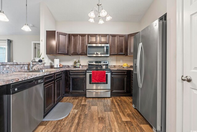 282 Foxpath Loop, Myrtle Beach, SC 29588 - kitchen with appliances with stainless steel finishes, a sink, dark brown cabinets, dark wood-type flooring, and a chandelier