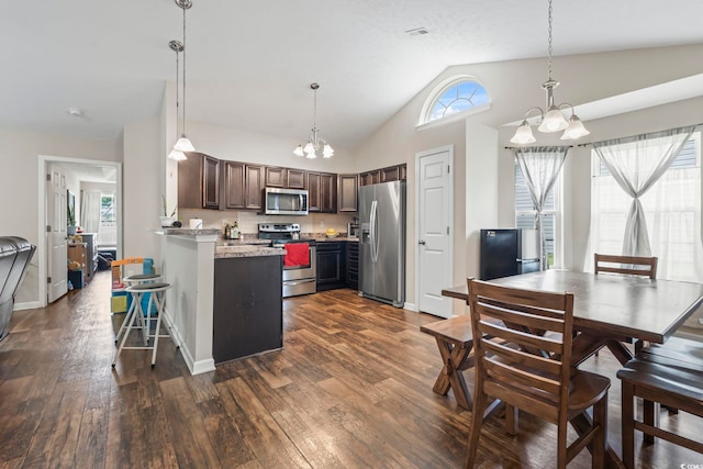 282 Foxpath Loop, Myrtle Beach, SC 29588 - kitchen featuring stainless steel appliances, a chandelier, a peninsula, dark wood finished floors, and vaulted ceiling