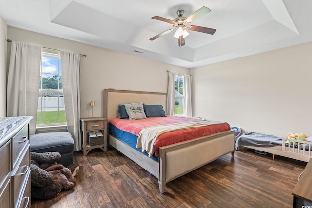 282 Foxpath Loop, Myrtle Beach, SC 29588 - bedroom featuring a raised ceiling, dark wood-style floors, and a ceiling fan
