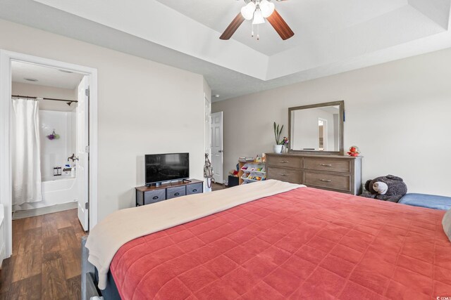 282 Foxpath Loop, Myrtle Beach, SC 29588 - bedroom with dark wood-style floors, a raised ceiling, connected bathroom, and ceiling fan