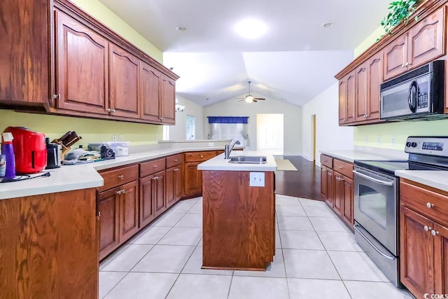 2499 Burning Tree Ln, Little River, SC 29566 - kitchen featuring black microwave, stainless steel range with electric stovetop, a sink, lofted ceiling, and a center island with sink