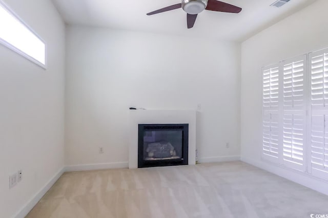2499 Burning Tree Ln, Little River, SC 29566 - unfurnished living room with a ceiling fan, carpet, a glass covered fireplace, and baseboards