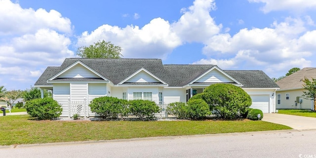 2499 Burning Tree Ln, Little River, SC 29566 - traditional home featuring a garage, concrete driveway, a shingled roof, and a front yard