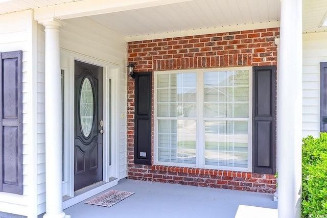 2499 Burning Tree Ln, Little River, SC 29566 - doorway to property featuring brick siding and covered porch
