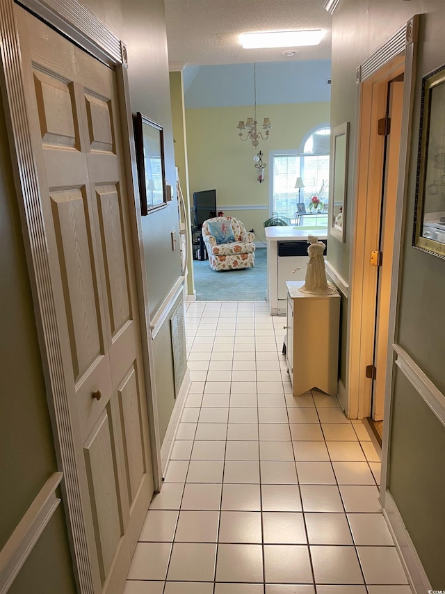 4753 Wild Iris Dr Unit 301, Myrtle Beach, SC 29577 - hall featuring light tile patterned floors and a chandelier