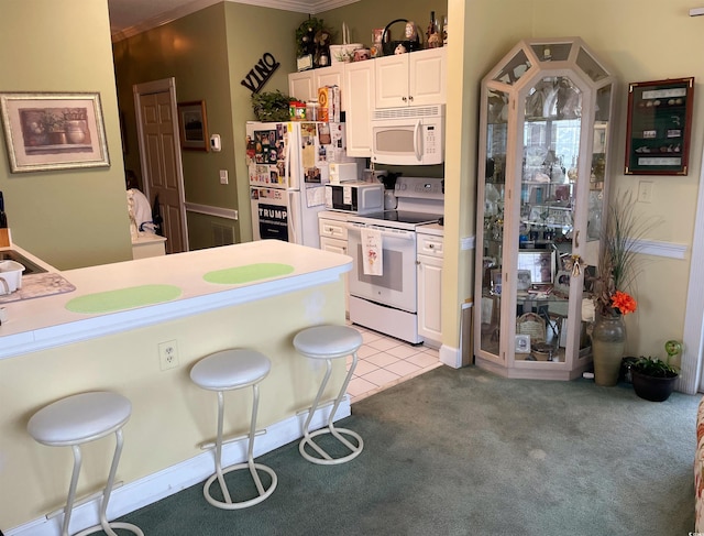 4753 Wild Iris Dr Unit 301, Myrtle Beach, SC 29577 - kitchen featuring white appliances, light colored carpet, white cabinets, light countertops, and crown molding