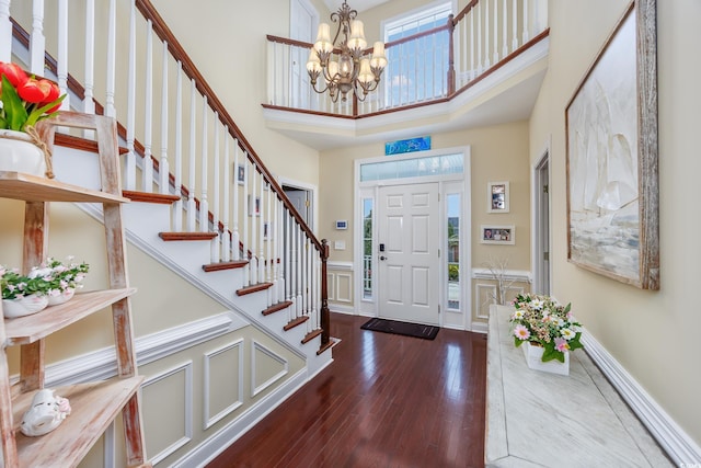 504 Sea Vista Ln, North Myrtle Beach, SC 29582 - foyer entrance featuring a towering ceiling, hardwood / wood-style floors, a chandelier, stairs, and a wainscoted wall