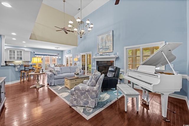 504 Sea Vista Ln, North Myrtle Beach, SC 29582 - living room with ceiling fan, a chandelier, hardwood / wood-style flooring, a towering ceiling, and a fireplace