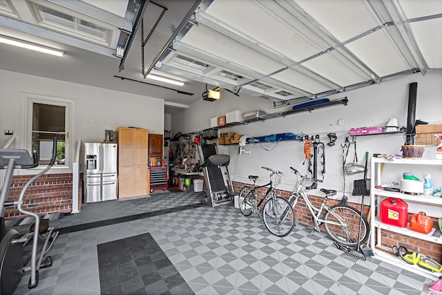 504 Sea Vista Ln, North Myrtle Beach, SC 29582 - garage featuring a garage door opener and stainless steel fridge