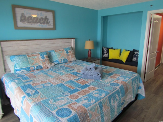 6804 N Ocean Blvd Unit 1023, Myrtle Beach, SC 29572 - bedroom featuring wood finished floors and a textured ceiling