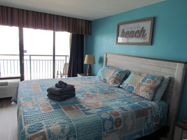 6804 N Ocean Blvd Unit 1023, Myrtle Beach, SC 29572 - bedroom featuring a textured ceiling and access to exterior