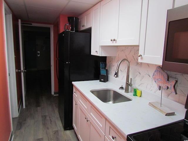 6804 N Ocean Blvd Unit 1023, Myrtle Beach, SC 29572 - kitchen with stainless steel microwave, light countertops, white cabinets, backsplash, and a paneled ceiling