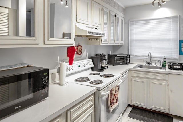 4505 N Kings Hwy # E2, Myrtle Beach, SC 29577 - kitchen with under cabinet range hood, black microwave, electric range, a sink, and light countertops