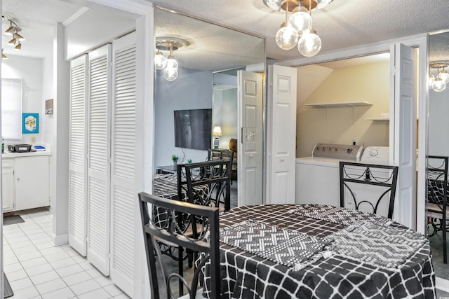 4505 N Kings Hwy # E2, Myrtle Beach, SC 29577 - dining room with light tile patterned floors, washer and dryer, and a textured ceiling
