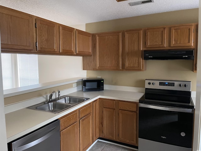 770 Charter Dr Unit C4, Longs, SC 29568 - kitchen featuring appliances with stainless steel finishes, range hood, light countertops, light tile patterned floors, and a textured ceiling