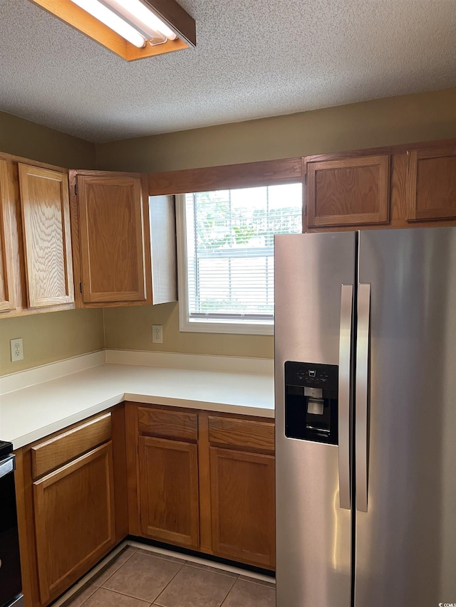770 Charter Dr Unit C4, Longs, SC 29568 - kitchen featuring stainless steel fridge, brown cabinets, and a textured ceiling