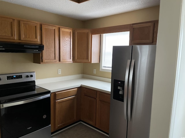 770 Charter Dr Unit C4, Longs, SC 29568 - kitchen featuring stainless steel appliances, range hood, light countertops, dark tile patterned floors, and a textured ceiling