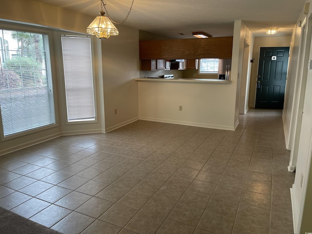 770 Charter Dr Unit C4, Longs, SC 29568 - kitchen featuring dark tile patterned floors, stainless steel fridge, a chandelier, decorative light fixtures, and light countertops