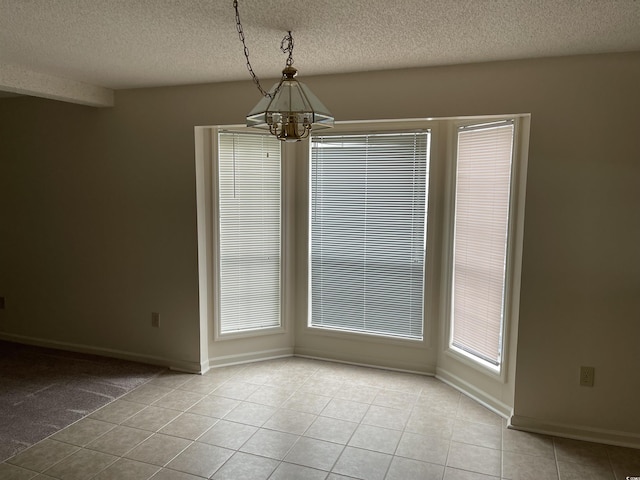 770 Charter Dr Unit C4, Longs, SC 29568 - unfurnished dining area with a chandelier, light tile patterned flooring, and a textured ceiling