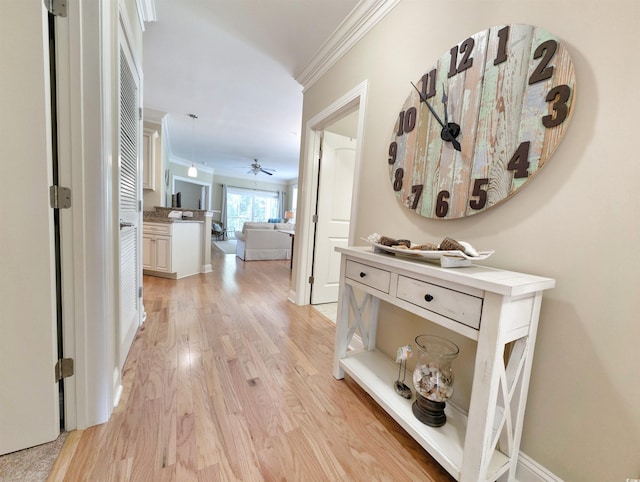 82 Mingo Dr Unit 2D, Pawleys Island, SC 29585 - hallway featuring crown molding, light wood finished floors, and baseboards