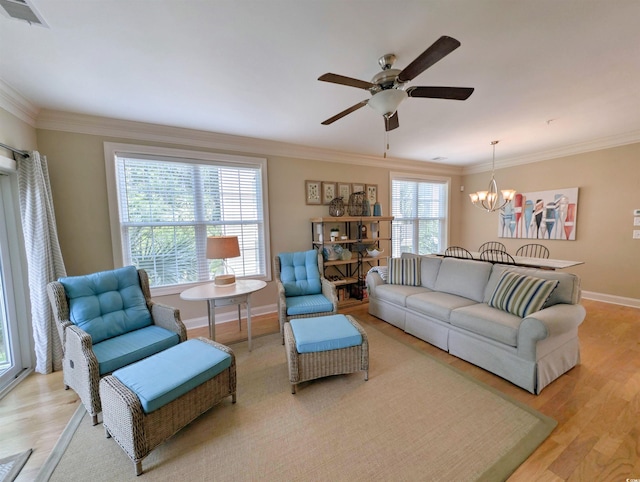 82 Mingo Dr Unit 2D, Pawleys Island, SC 29585 - living area featuring a chandelier, ceiling fan, light wood-style floors, ornamental molding, and baseboards