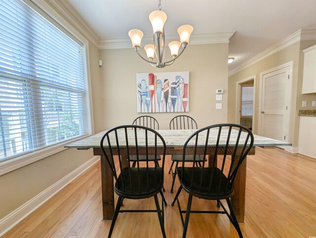 82 Mingo Dr Unit 2D, Pawleys Island, SC 29585 - dining space with baseboards, light wood-type flooring, crown molding, and a chandelier