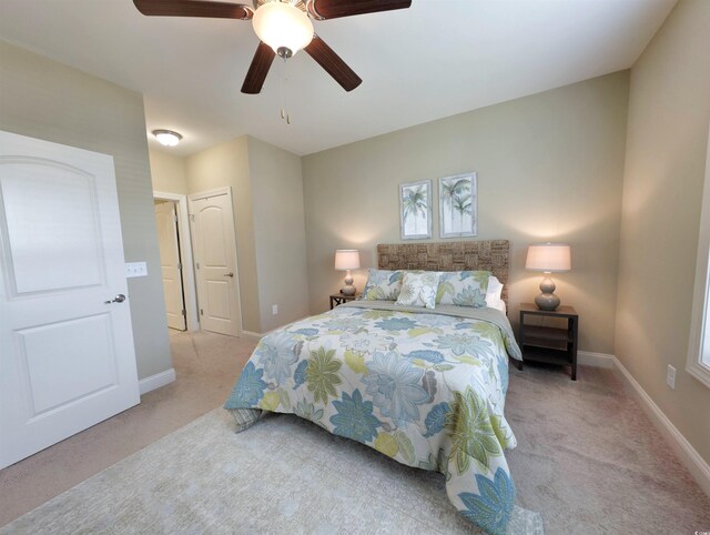 82 Mingo Dr Unit 2D, Pawleys Island, SC 29585 - carpeted bedroom featuring baseboards and ceiling fan
