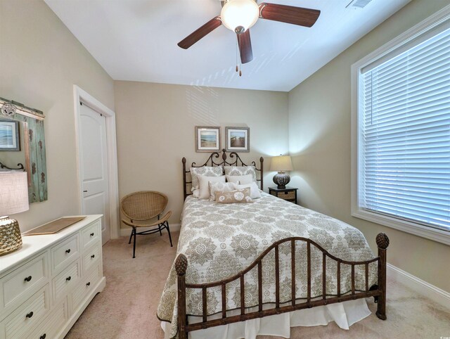 82 Mingo Dr Unit 2D, Pawleys Island, SC 29585 - bedroom featuring light colored carpet, baseboards, and ceiling fan