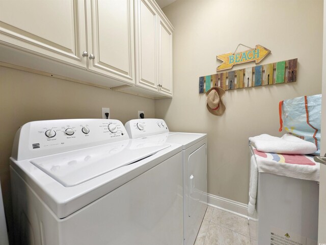82 Mingo Dr Unit 2D, Pawleys Island, SC 29585 - laundry room with washer and clothes dryer, cabinet space, baseboards, and light tile patterned floors