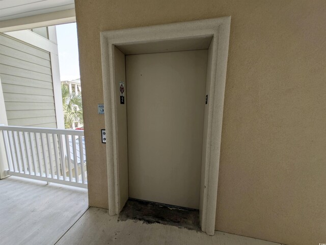 82 Mingo Dr Unit 2D, Pawleys Island, SC 29585 - property entrance featuring elevator and stucco siding