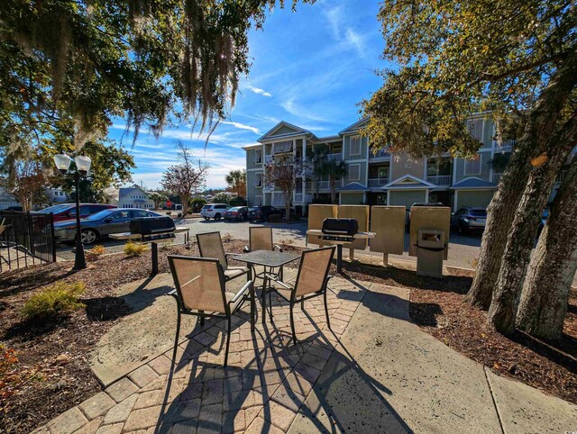 82 Mingo Dr Unit 2D, Pawleys Island, SC 29585 - view of patio featuring outdoor dining space and a grill