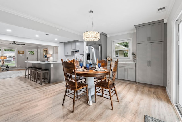 1223 Naylor Ave, Myrtle Beach, SC 29577 - dining area with light wood-type flooring, crown molding, a chandelier, recessed lighting, and ceiling fan