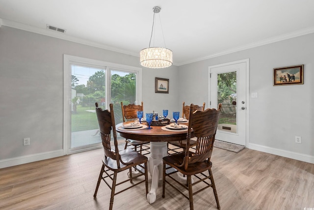 1223 Naylor Ave, Myrtle Beach, SC 29577 - dining space featuring healthy amount of natural light, crown molding, light wood-style flooring, a chandelier, and baseboards