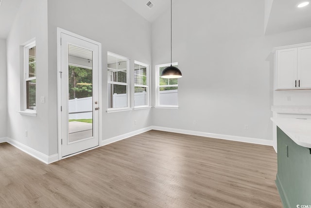 218 Calhoun Falls Dr, Myrtle Beach, SC 29579 - unfurnished dining area with light wood finished floors, baseboards, and high vaulted ceiling