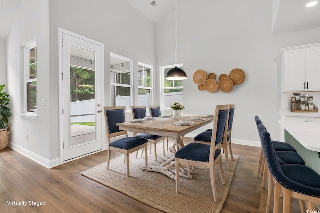 218 Calhoun Falls Dr, Myrtle Beach, SC 29579 - dining area featuring baseboards, wood finished floors, and high vaulted ceiling