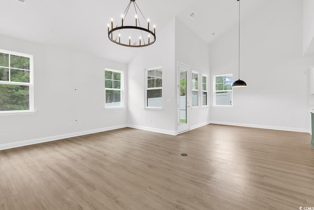 218 Calhoun Falls Dr, Myrtle Beach, SC 29579 - unfurnished living room with a chandelier, wood finished floors, healthy amount of natural light, high vaulted ceiling, and baseboards