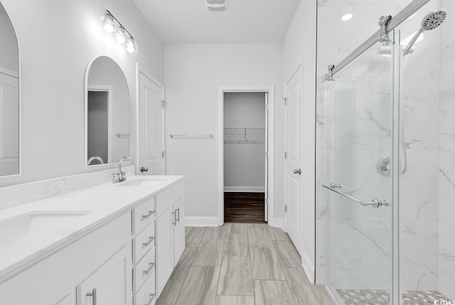 218 Calhoun Falls Dr, Myrtle Beach, SC 29579 - full bathroom featuring a marble finish shower, double vanity, a walk in closet, and baseboards