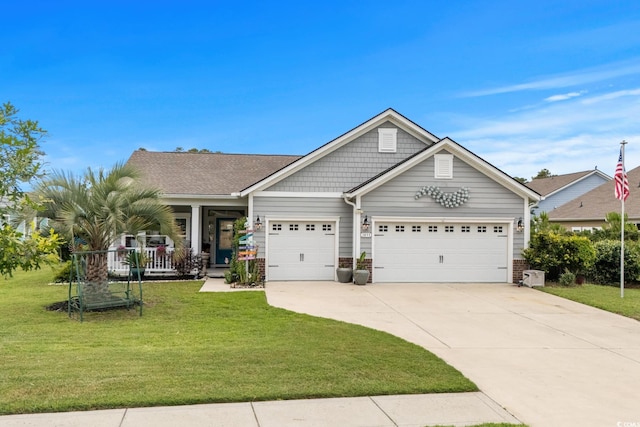 1833 Lake Egret Dr, North Myrtle Beach, SC 29582 - view of front of house featuring a front lawn, an attached garage, driveway, covered porch, and brick siding