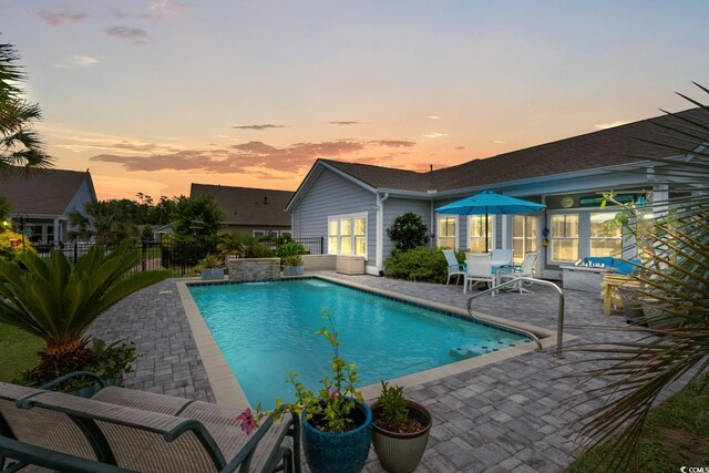 1833 Lake Egret Dr, North Myrtle Beach, SC 29582 - pool at dusk featuring a patio