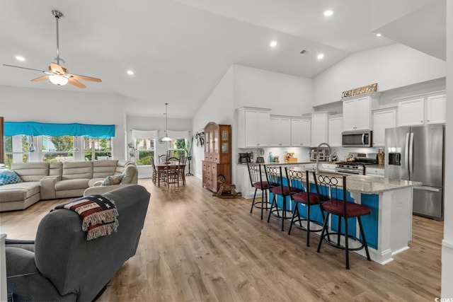 1833 Lake Egret Dr, North Myrtle Beach, SC 29582 - living room featuring high vaulted ceiling, light wood finished floors, a ceiling fan, and recessed lighting