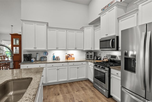 1833 Lake Egret Dr, North Myrtle Beach, SC 29582 - kitchen with stainless steel appliances, white cabinetry, and a sink