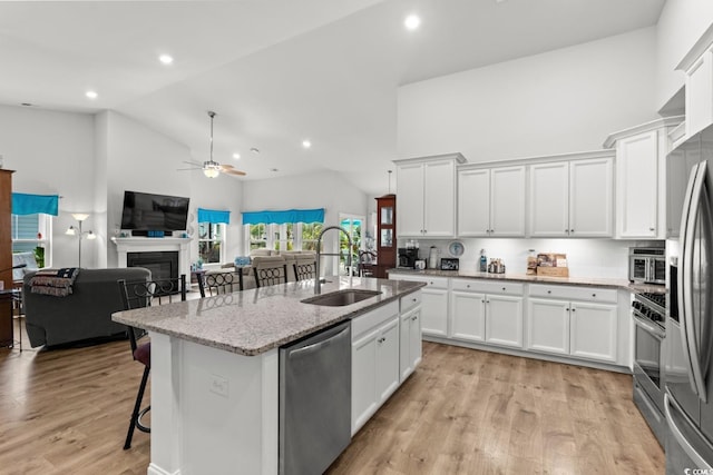 1833 Lake Egret Dr, North Myrtle Beach, SC 29582 - kitchen with high vaulted ceiling, appliances with stainless steel finishes, a sink, open floor plan, and a ceiling fan